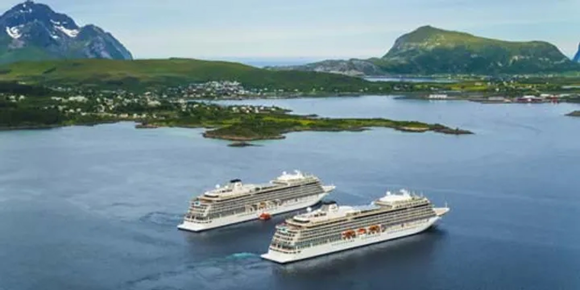 Cruise Ships in Norwegian Fjord Landscape Two modern white cruise ships anchored in a picturesque Norwegian fjord, surrounded by lush green mountains and a small coastal town in the background.