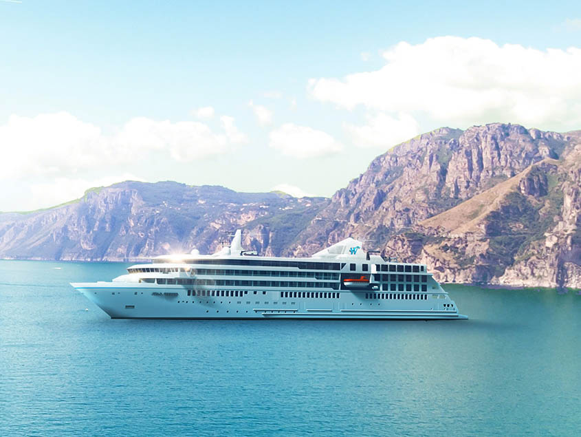 A sleek white cruise ship sailing through turquoise waters with dramatic rocky mountains in the background. The vessel appears to be a modern, multi-decked luxury cruise liner positioned in a scenic maritime setting.