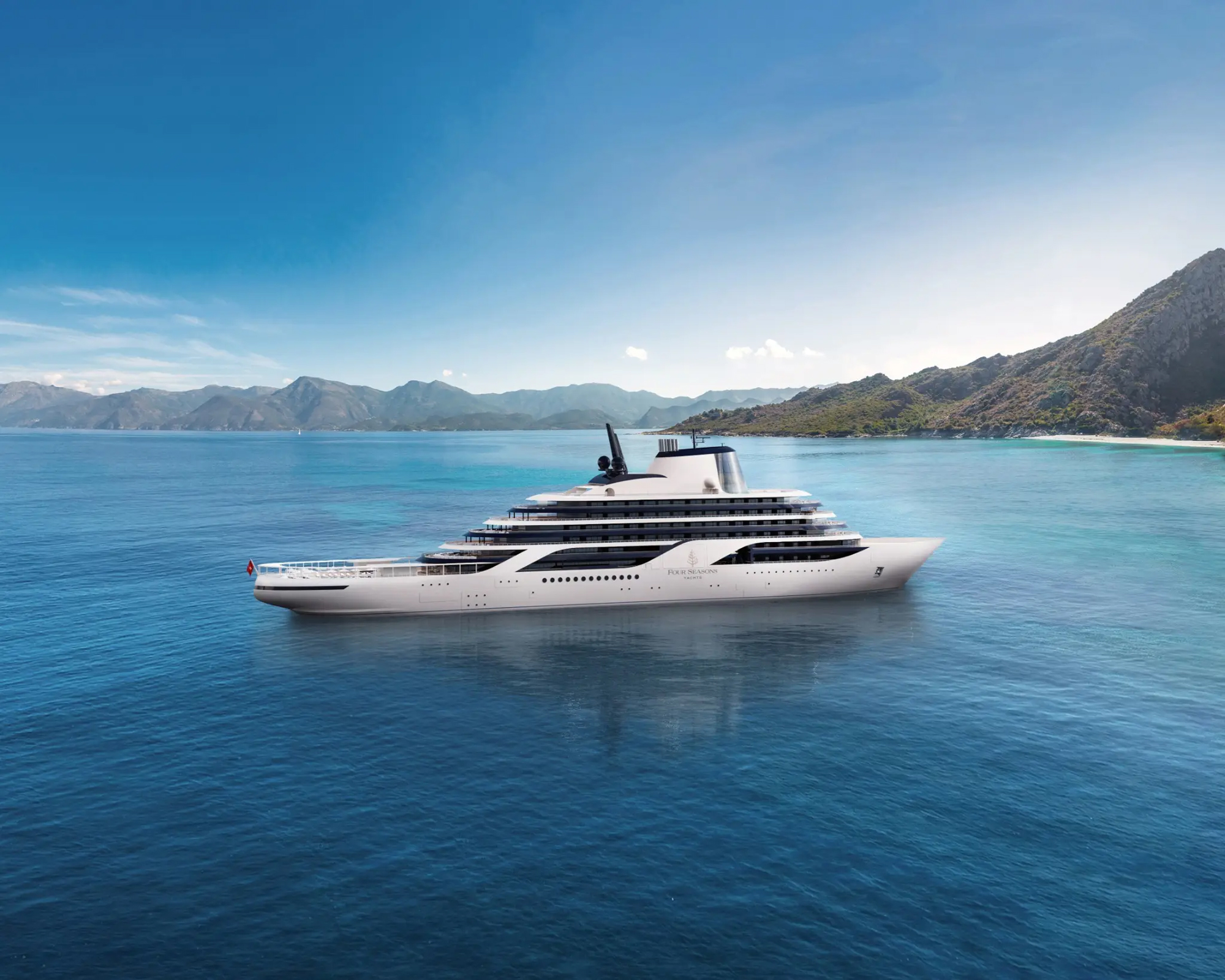 A sleek, modern white cruise ship anchored in a tranquil blue bay surrounded by rugged mountainous coastline and clear turquoise waters.