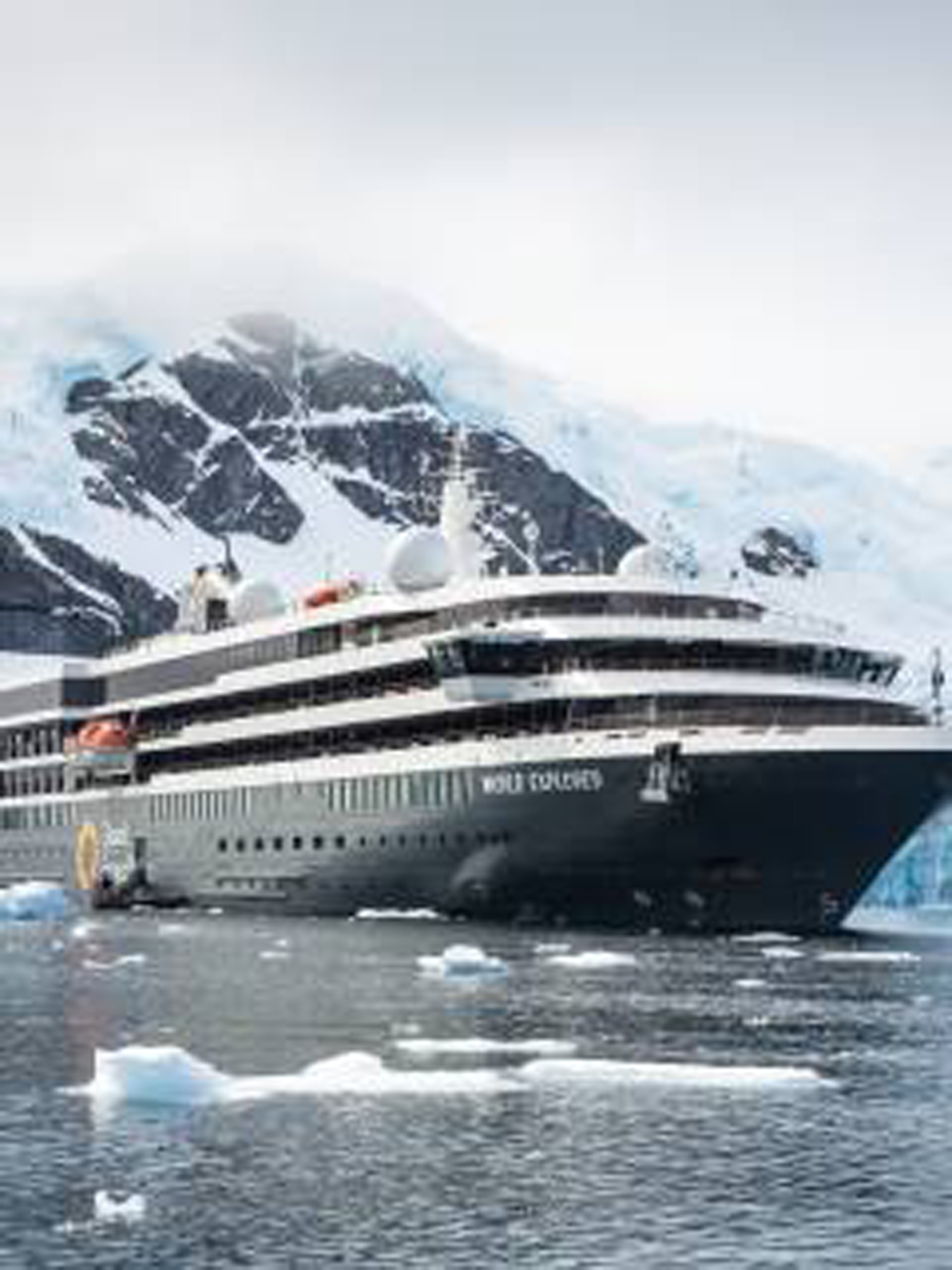 Luxury Expedition Cruise in Antarctic Waters A modern expedition cruise ship navigating through icy waters with snow-capped mountains in the background, surrounded by floating ice fragments
