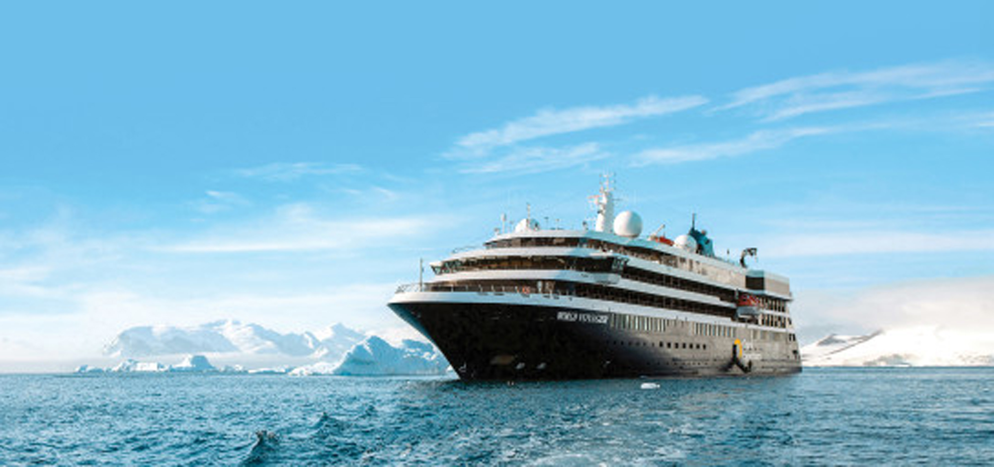 Luxury Expedition Cruise in Antarctic Waters A sleek modern cruise ship navigating through icy blue waters with snow-covered mountains and icebergs in the background. The vessel appears to be designed for polar expedition cruising.