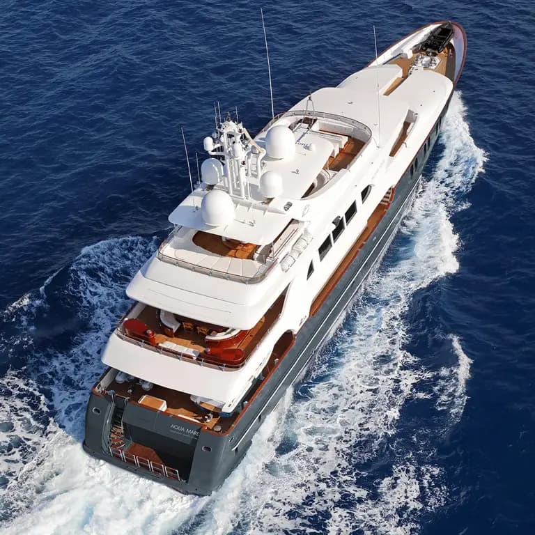 Luxury Yacht Cruising Deep Blue Waters A sleek white multi-level luxury yacht cutting through deep blue ocean waters, showcasing its elegant design and powerful movement.