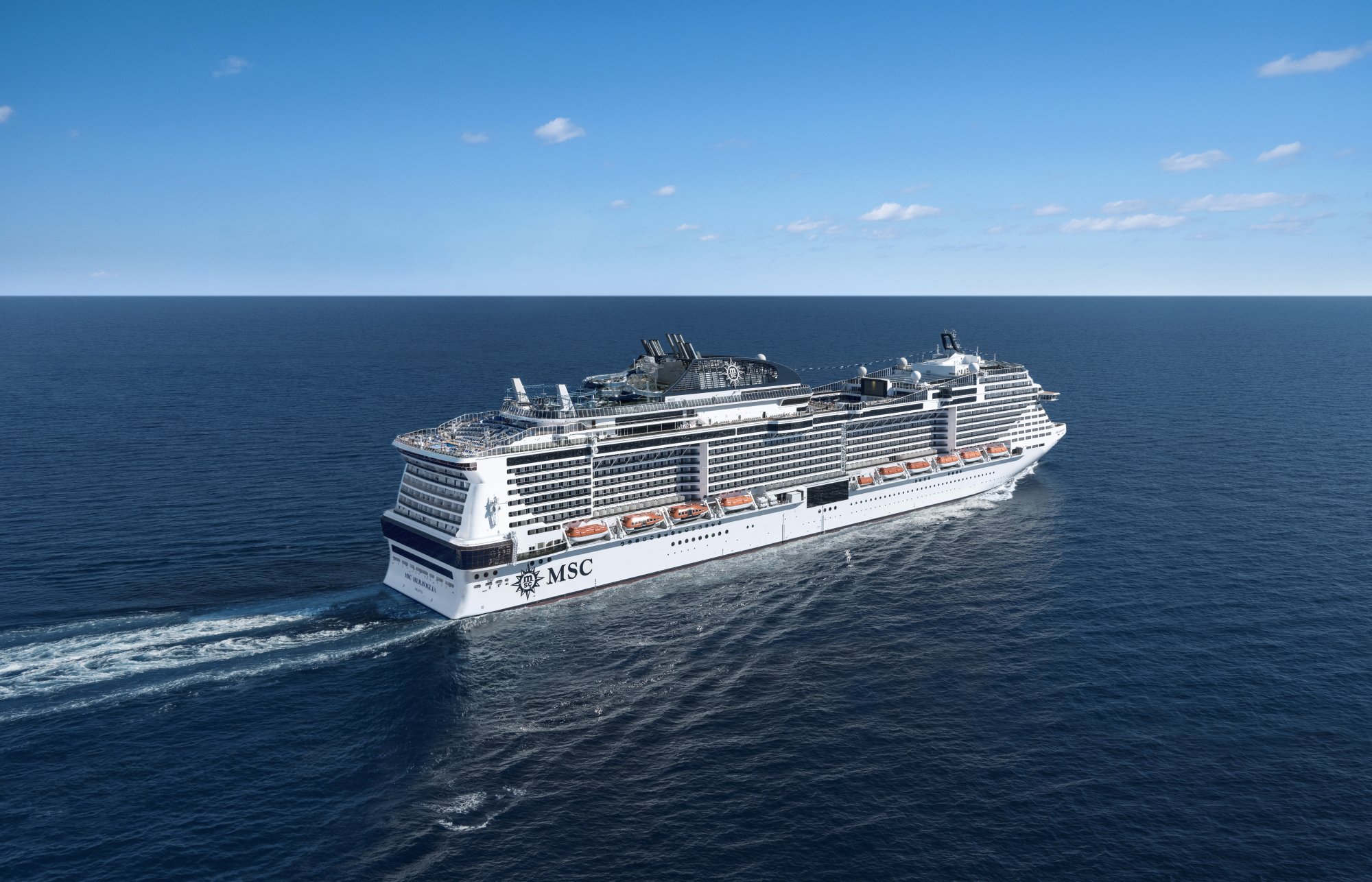MSC Meraviglia Cruise Ship at Sea A large modern cruise ship from MSC Cruises sailing on open ocean under clear skies. The vessel features distinctive white hull with MSC branding, multiple decks with balconies, and integrated entertainment structures on the upper decks.