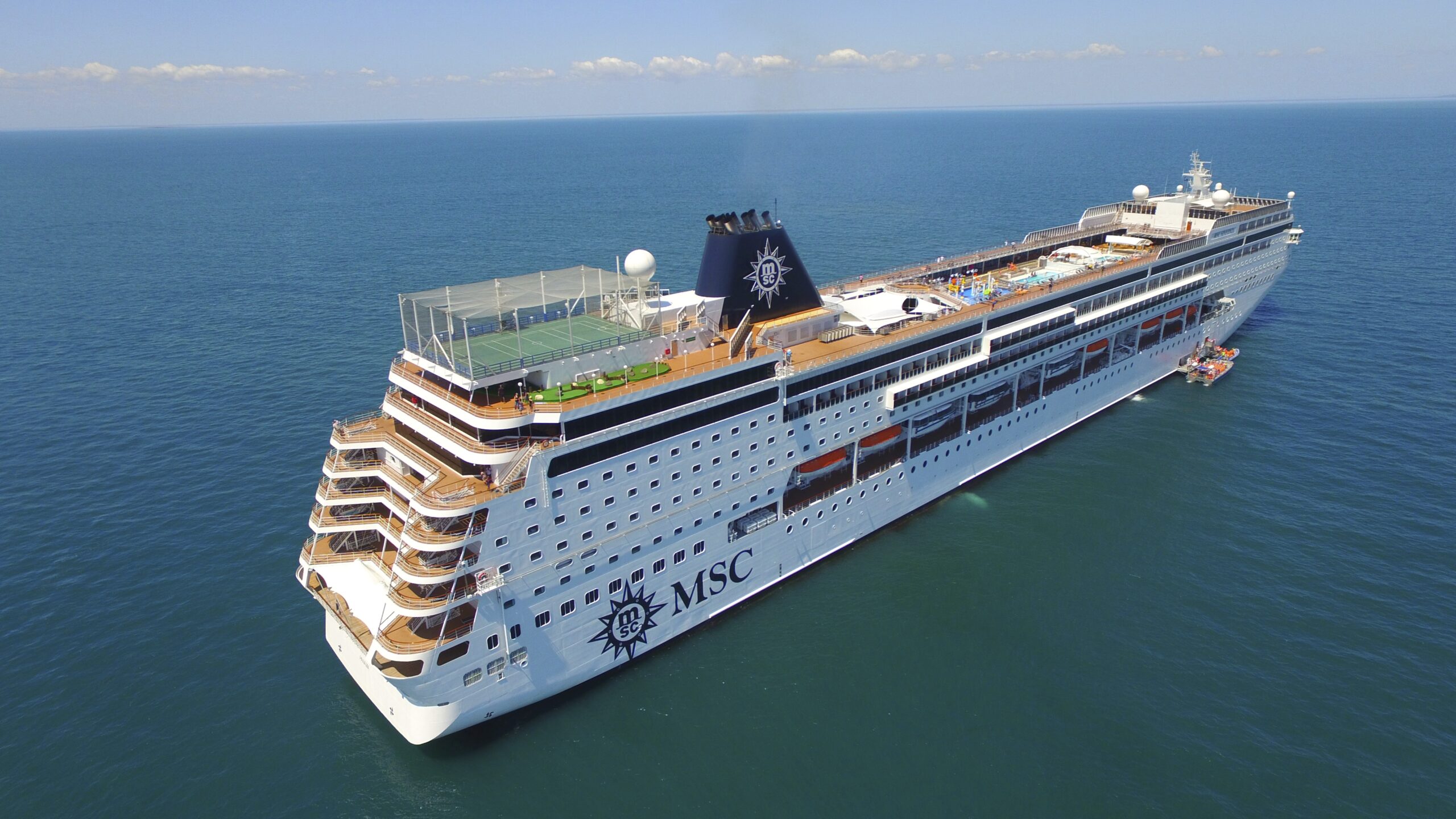 MSC Sinfonia Cruise Ship at Sea A modern cruise ship with distinctive MSC branding on the hull, photographed from an aerial