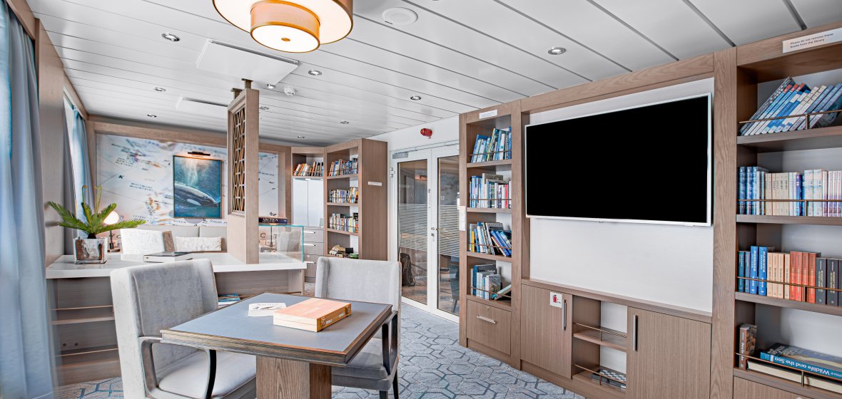Modern Library and Lounge Area on Cruise Ship Modern library and lounge area aboard an Albatross expedition cruise ship with comfortable seating and bookshelves.