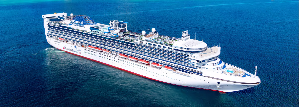 Carnival Adventure Cruise Ship at Sea A large modern cruise ship operated by Carnival Cruise Lines sails through deep blue ocean waters