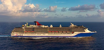 Carnival Legend Cruise Ship at Sea A large modern cruise ship from Carnival Cruise Lines sails through open ocean waters under
