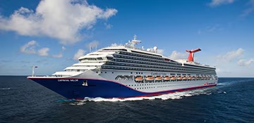 Carnival Valor Cruise Ship at Sea A large modern cruise ship with distinctive blue hull and red funnel stack cruising through calm